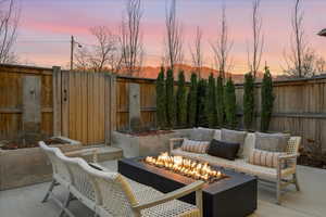 Fenced backyard with a patio and a fire pit