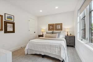 Carpeted bedroom with baseboards and recessed lighting