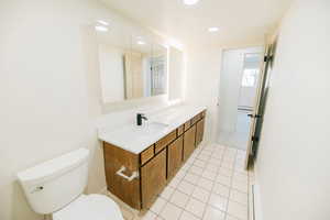 Bathroom featuring vanity, light tile patterned floors, and recessed lighting