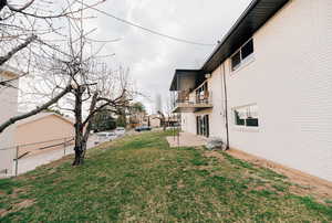 Fenced yard with a balcony and a patio
