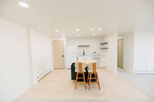 Dining room with recessed lighting and baseboard heating