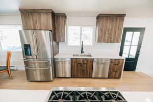 Kitchen with stainless steel appliances, modern cabinets, and healthy amount of natural light