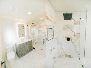 Bathroom featuring a marble finish shower, vanity, and recessed lighting