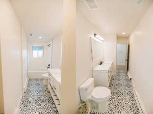 Full bathroom featuring vanity, light tile patterned flooring, recessed lighting,  shower combination, and a baseboard heating unit