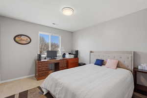Bedroom with baseboards and light tile patterned flooring