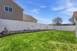 Fenced backyard featuring a gate