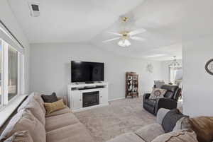 Living room with ceiling fan, light colored carpet, and fan