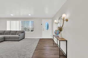 Entrance foyer with wood finished floors and recessed lighting