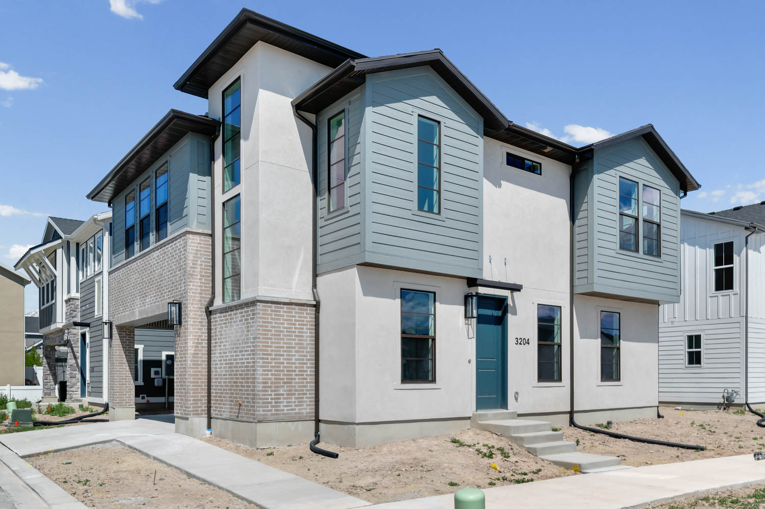 Contemporary house featuring stucco siding and brick siding