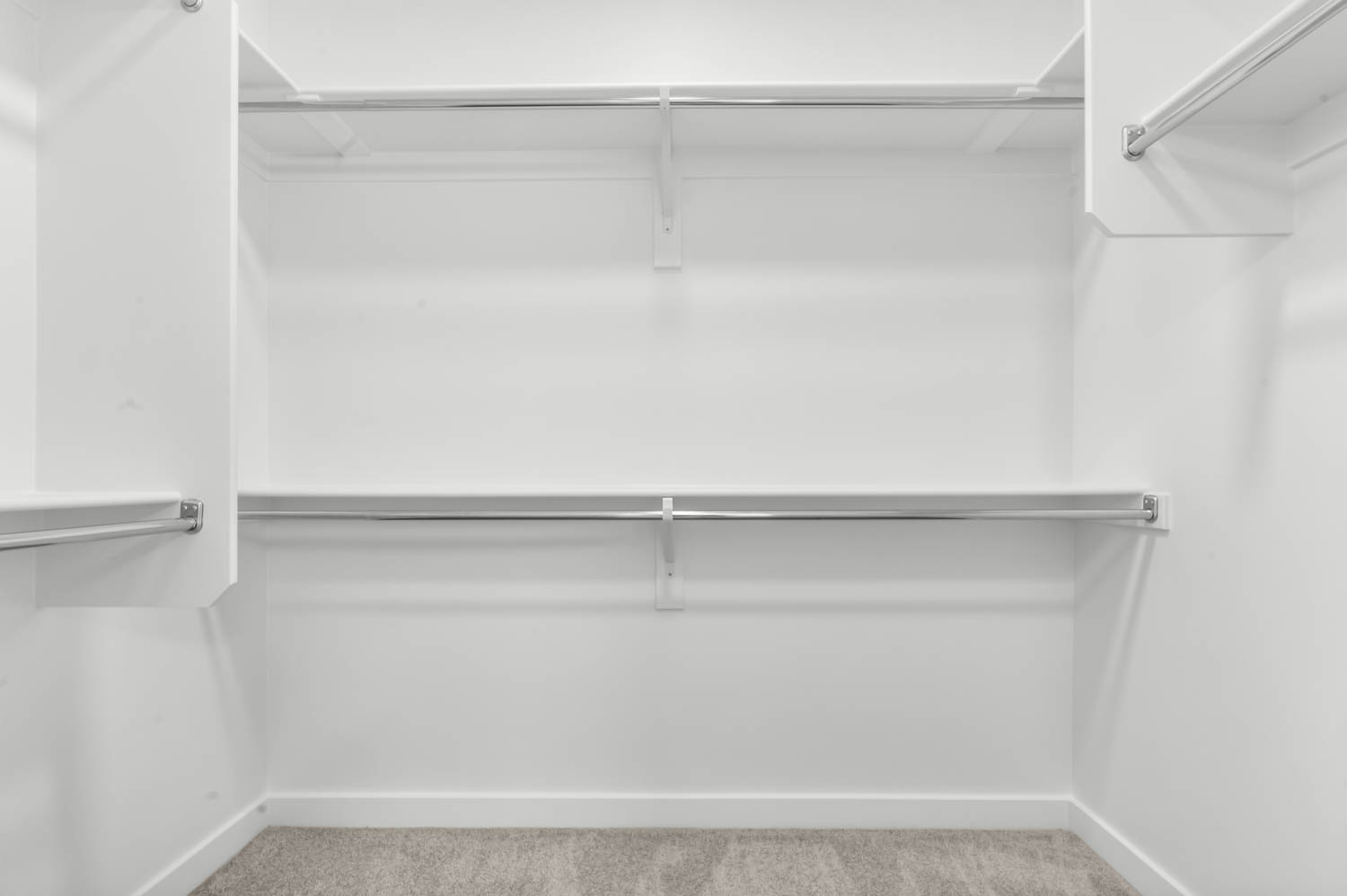Walk in closet featuring light colored carpet