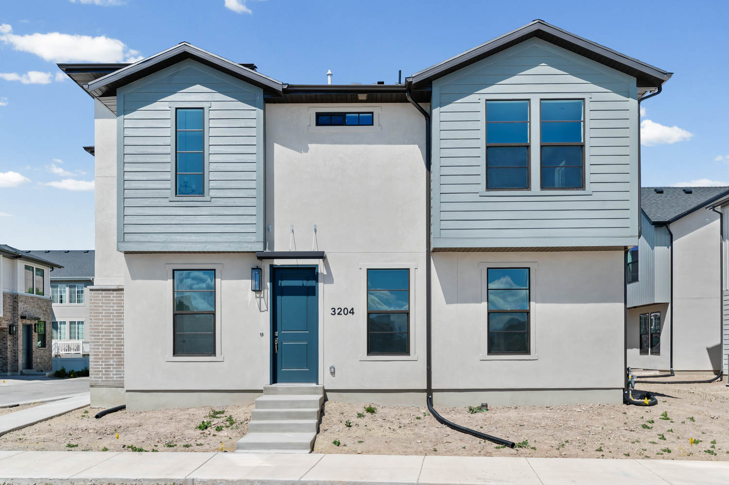 View of front facade featuring stucco siding