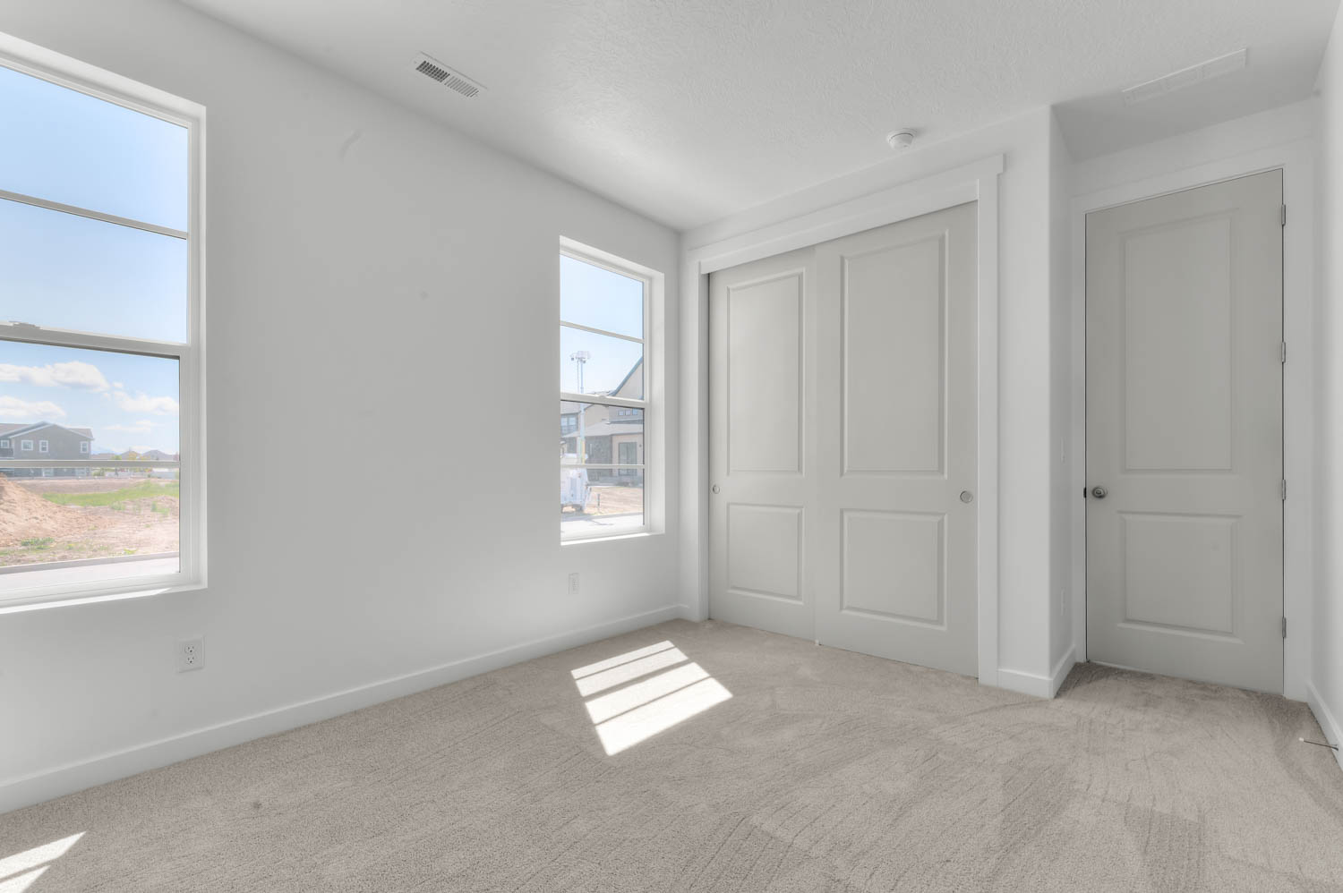 Unfurnished bedroom featuring light colored carpet and a closet