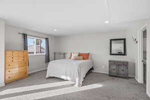 Bedroom with light carpet and recessed lighting