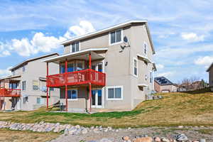 View of front of property with a patio area, a front yard, and stucco siding