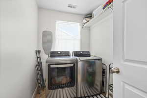 Laundry room with washer and dryer and baseboards