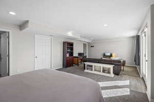 Carpeted bedroom with recessed lighting and baseboards