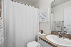 Full bath featuring vanity and curtained shower