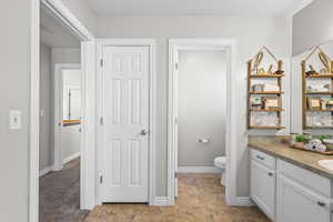 Bathroom featuring vanity and stone finish floors