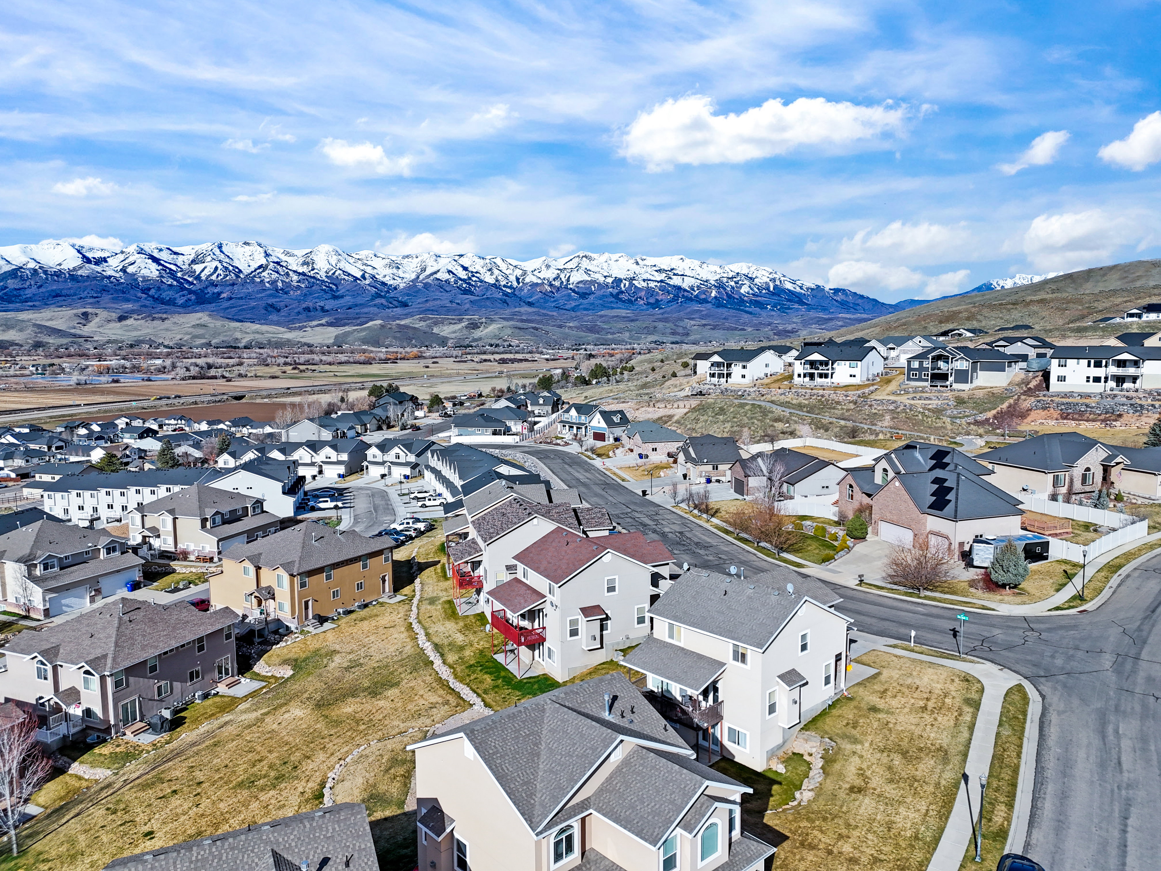 Aerial perspective of suburban area with a mountain backdrop