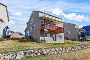 Rear view of property with a patio, a lawn, and stucco siding