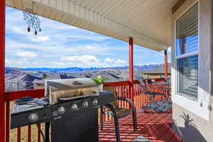 Wooden terrace featuring a grill and a mountain view