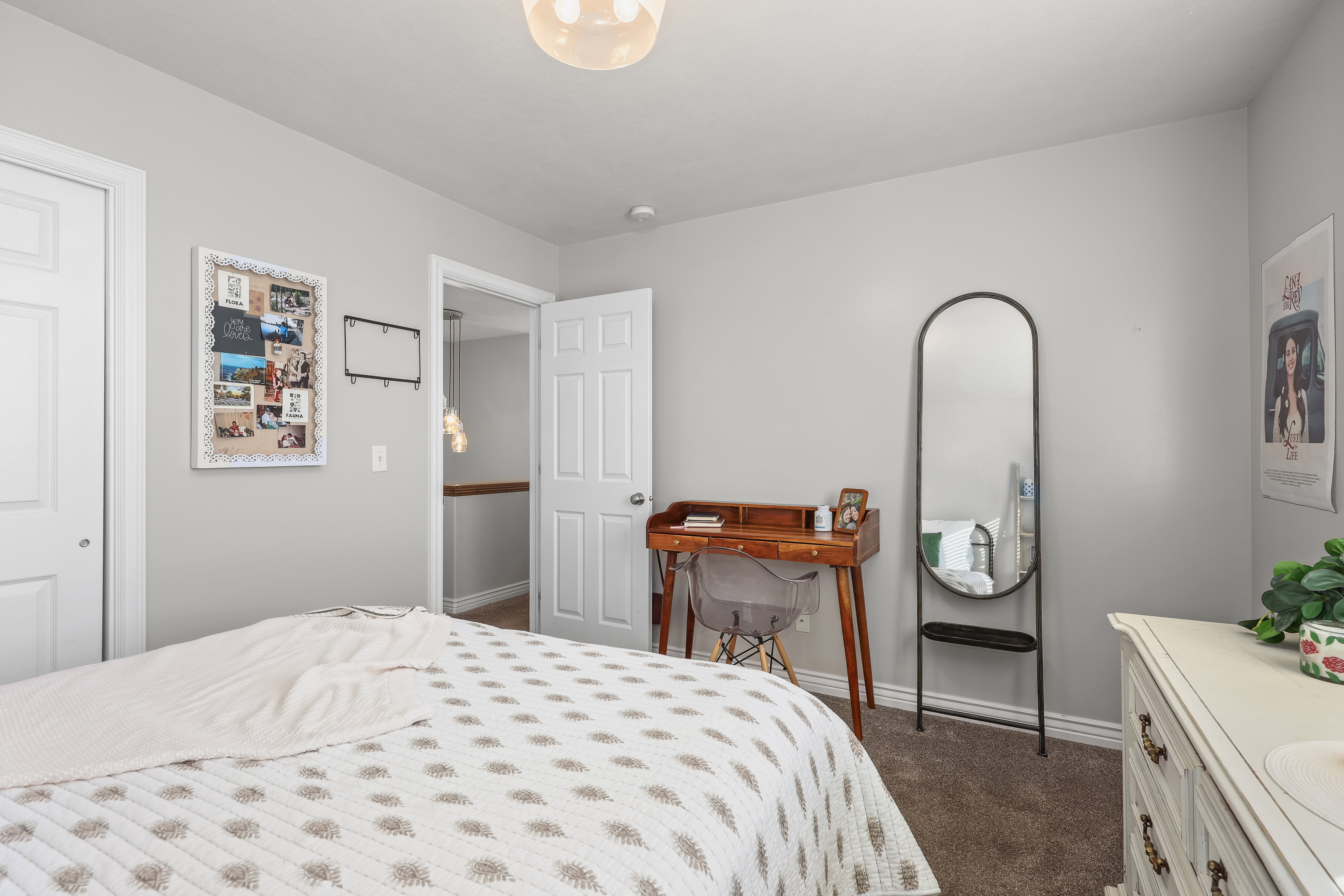 Bedroom with baseboards and dark carpet