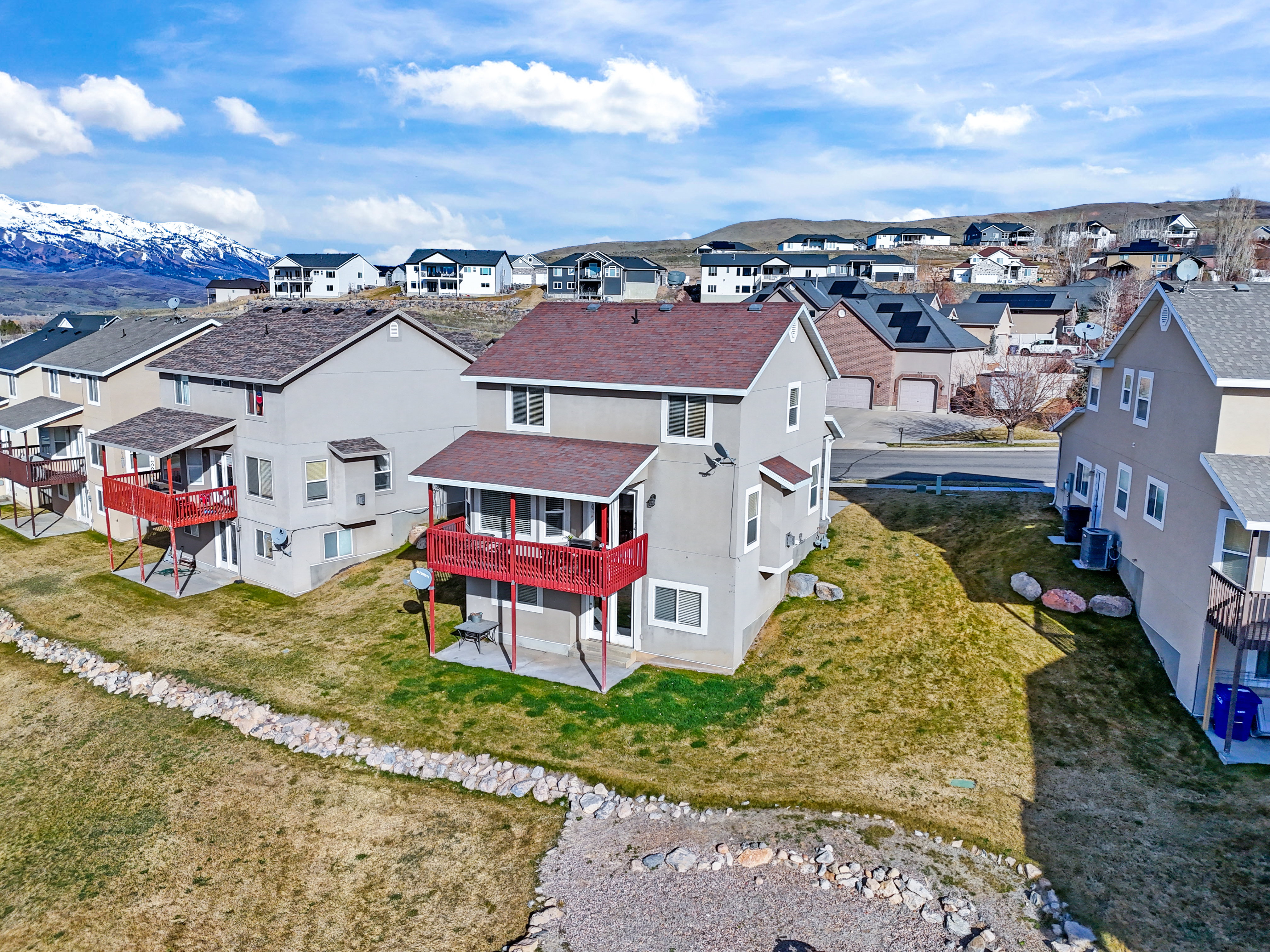 Aerial perspective of suburban area with a mountainous background