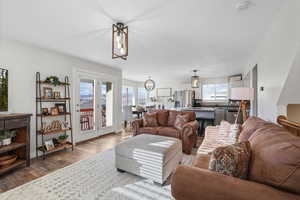 Living room featuring dark wood-style floors and a chandelier