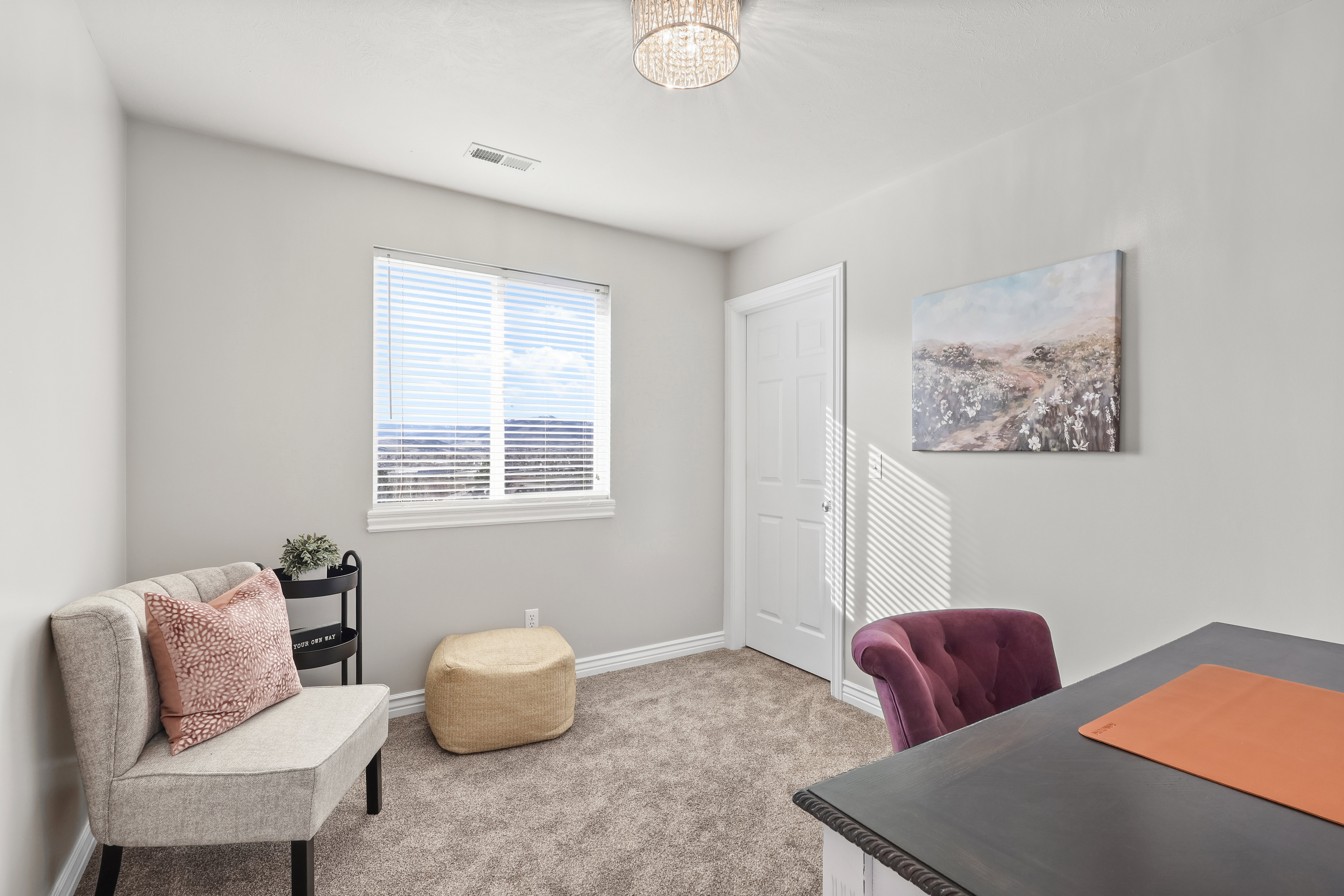 Home office featuring carpet floors and hanging lights