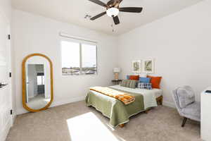 Bedroom with light carpet and a ceiling fan