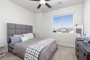Bedroom featuring light carpet and a ceiling fan
