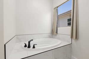 Full bathroom with a garden tub