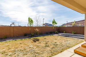 Fenced backyard with a patio area
