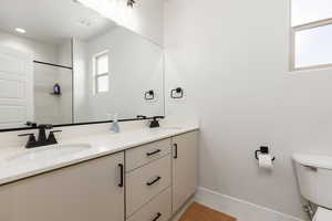 Full bath featuring double vanity, light tile patterned floors, and a shower