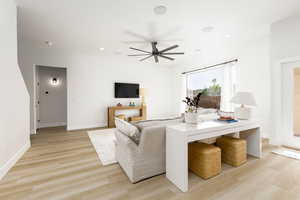 Living room featuring light wood-style floors, a ceiling fan, and recessed lighting