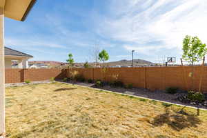 Fenced backyard featuring a mountain view
