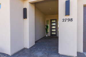 Doorway to property with stucco siding