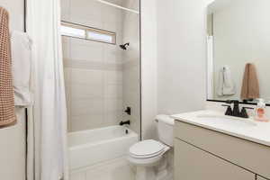 Bathroom featuring vanity and shower / bath combo