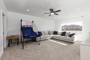Living room with light carpet, recessed lighting, a ceiling fan, and a mountain view