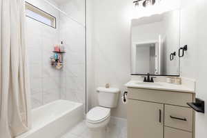 Full bath with vanity and shower / bath combination with curtain