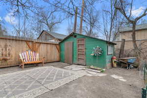 View of shed with a fenced backyard