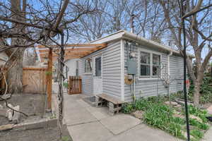 View of side of home with a gate