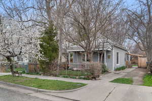 View of front of home with a fenced front yard and a porch