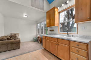 Kitchen featuring light countertops, light wood finished floors, open floor plan, and wood finish cabinets