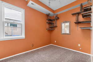 Spare room featuring carpet and a textured ceiling