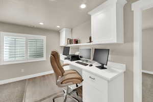 Office space with recessed lighting and light wood-style floors
