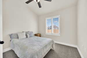 Bedroom with carpet flooring, lofted ceiling, and a ceiling fan