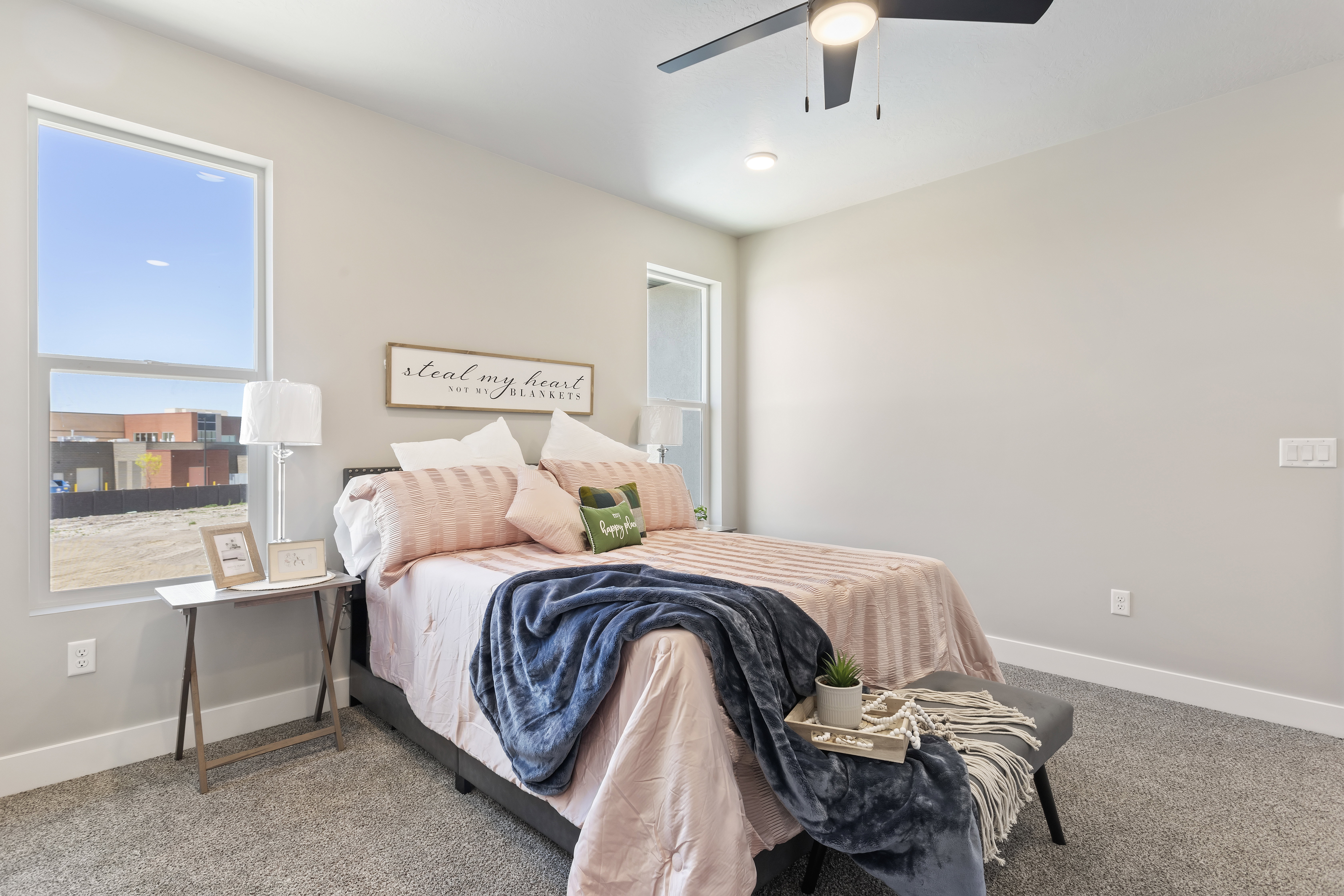Carpeted bedroom featuring baseboards and a ceiling fan