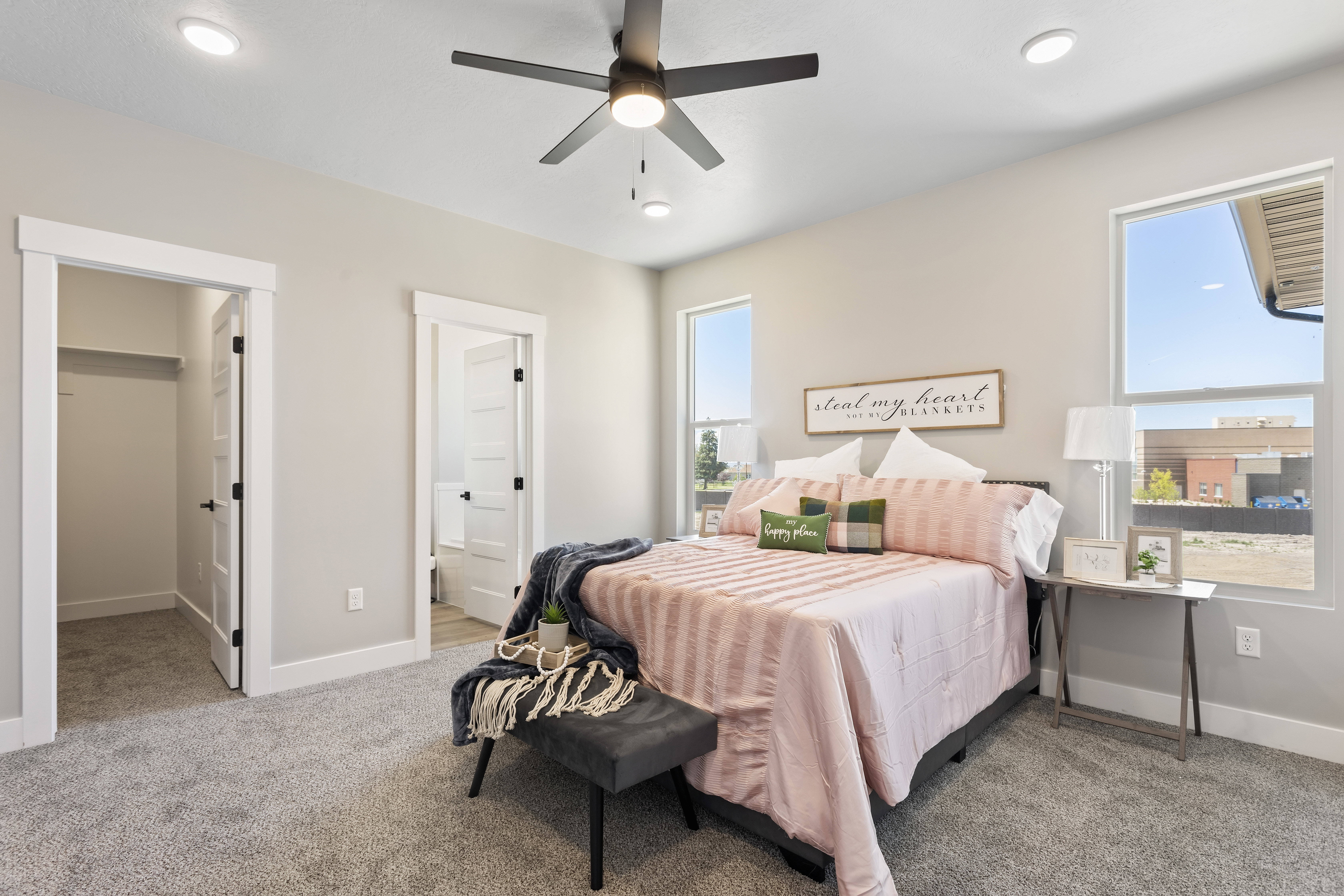 Bedroom featuring light colored carpet, a spacious closet, ceiling fan, connected bathroom, and recessed lighting