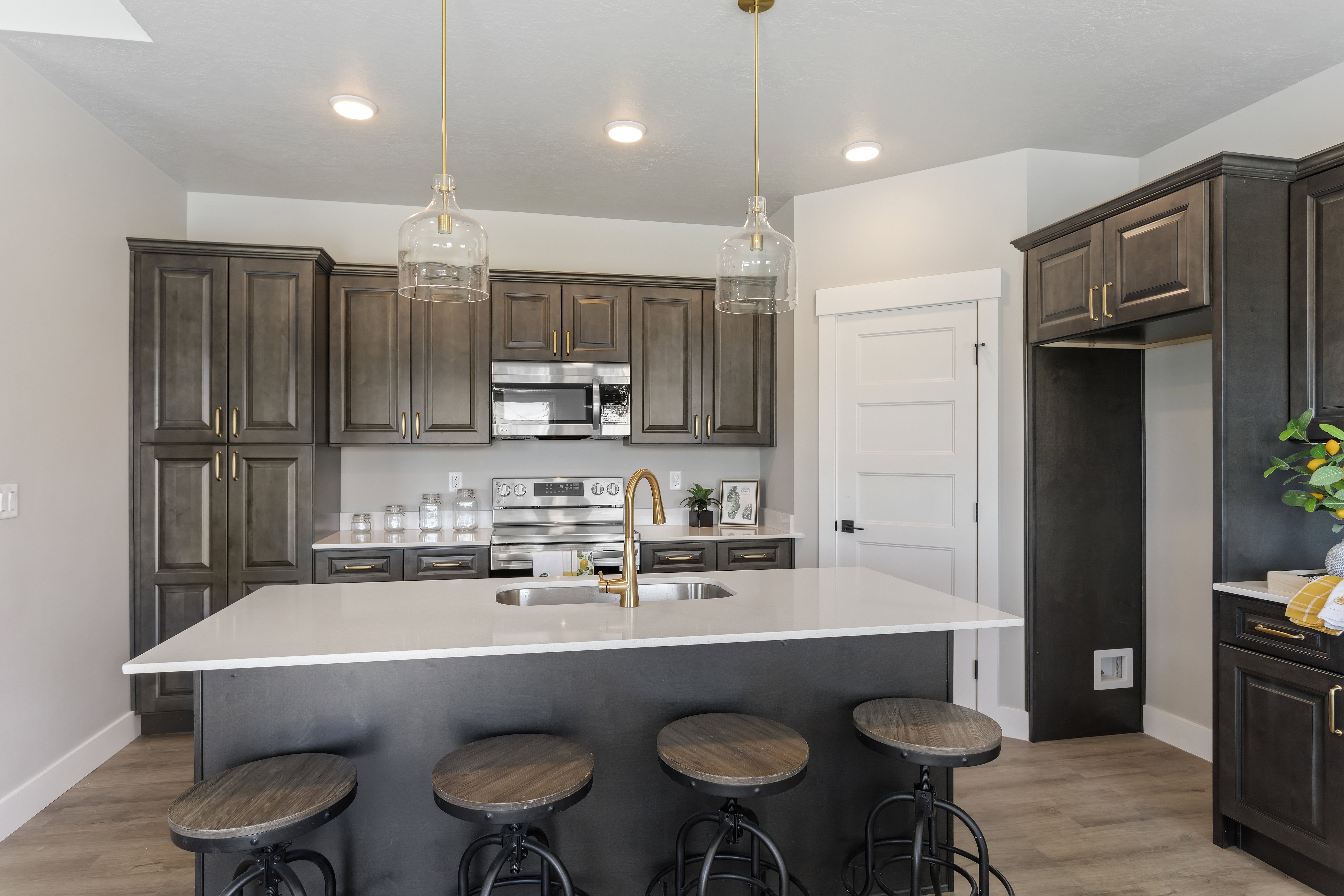 Kitchen featuring dark wood finish cabinets, a kitchen bar, and stainless steel appliances